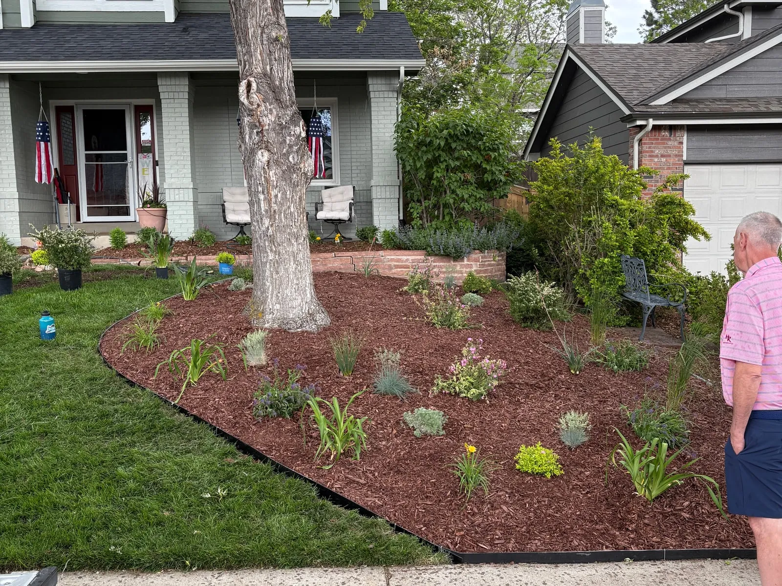 After: a fresh mulch bed with new plantings and a clean cut edge